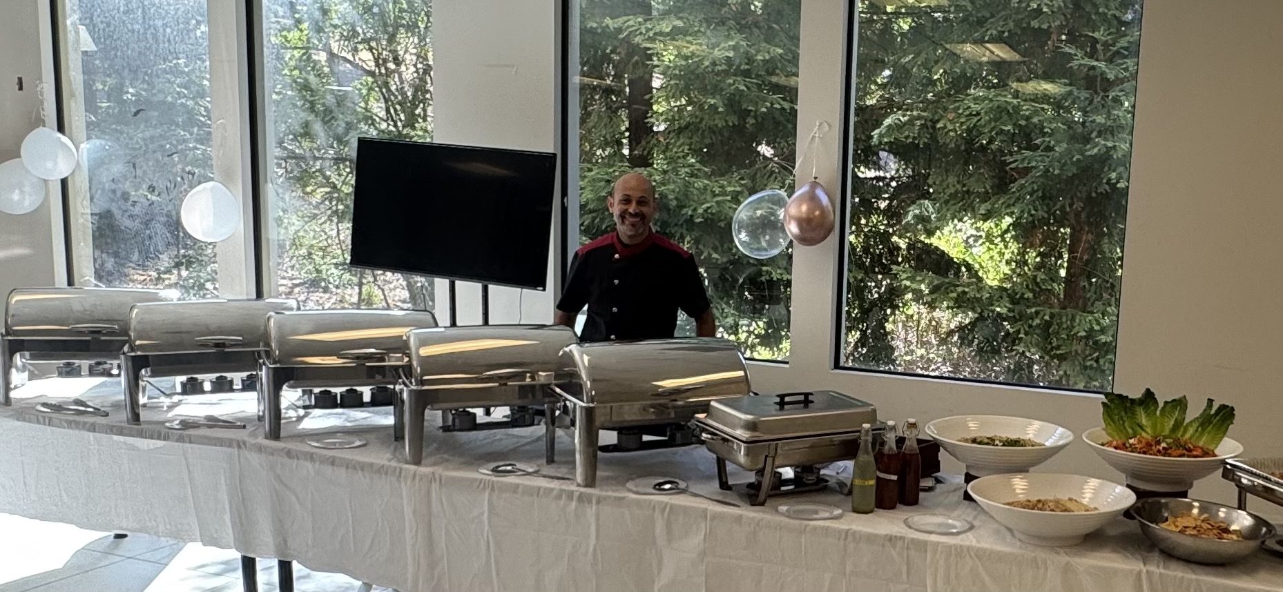 Indoor buffet with serving trays and salads