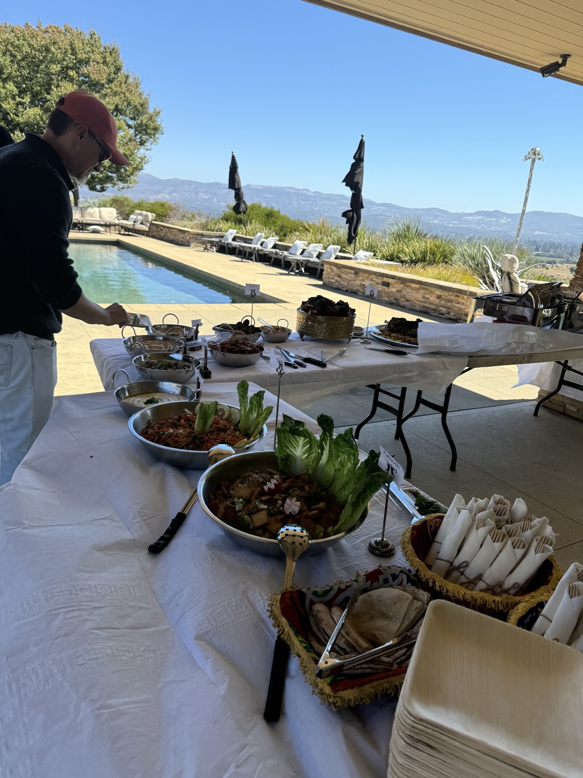Outdoor buffet with guests and serving tables